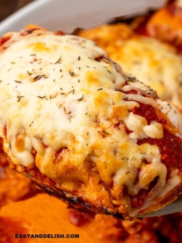 a breast of gluten-free chicken parmesan baked and then lifted witha spatula to be served