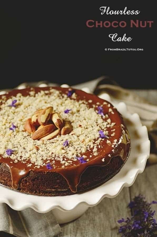 Flourless Chocolate Nut Cake topped with chocolate glaze and ground Brazil nuts