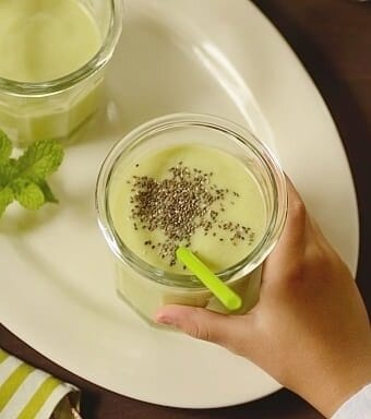 Instant Breakfast Avocado Smoothie in a glass with a green straw