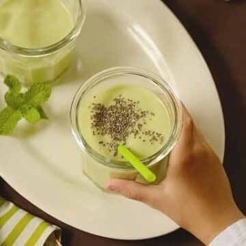Instant Breakfast Avocado Smoothie in a glass with a green straw