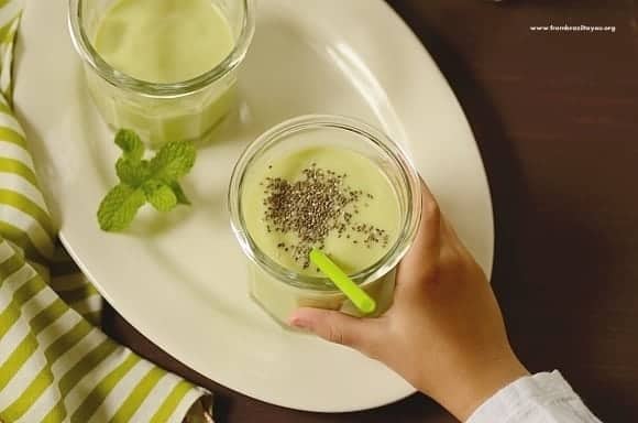 Instant Breakfast Avocado Smoothie in a glass with a green straw
