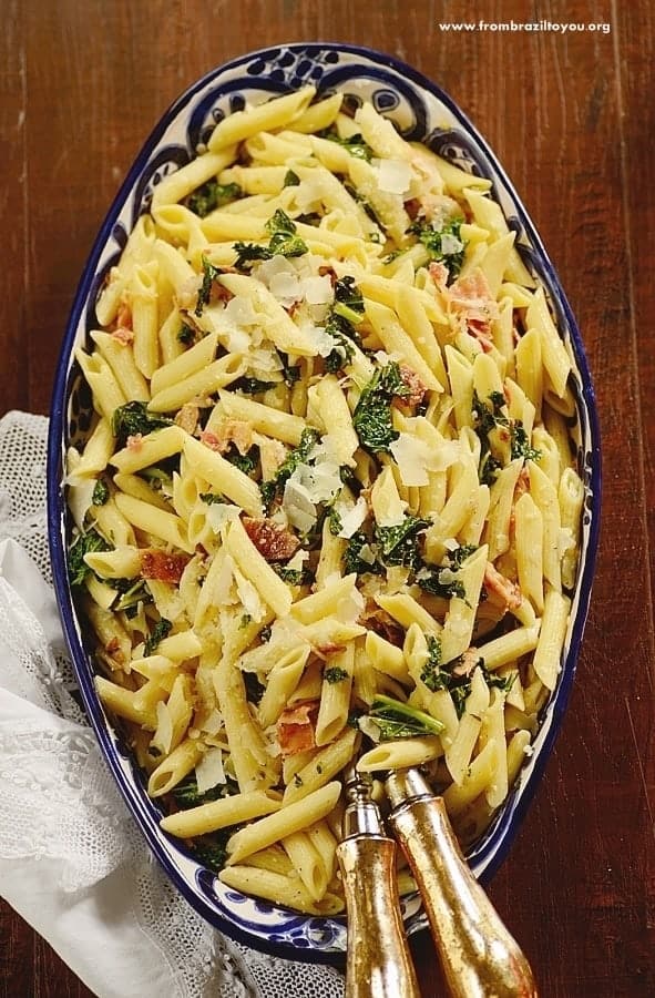 kale pasta salad in a platter with silverware