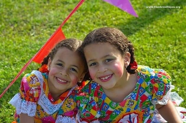 Two girls dressed in colorful hillbilly outfits