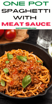 one pot spaghetti with meat sauce with some tomatoes in the background.