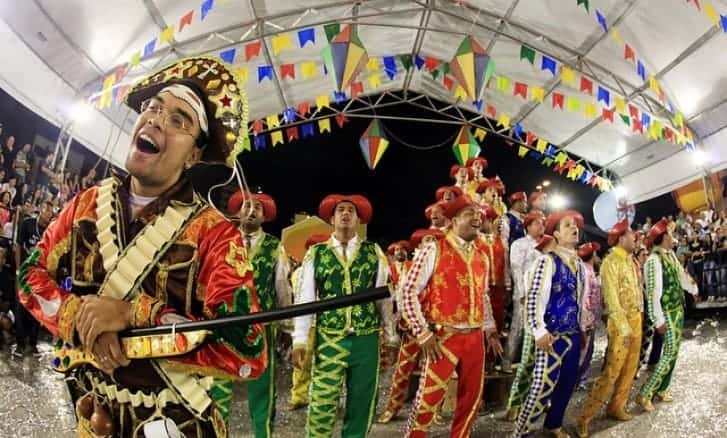 June festivals with people dancing under a decorated tent