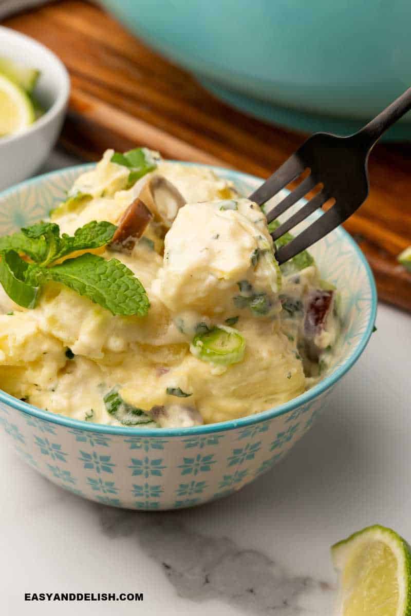 Brazilian potato salad served in a bowl and eaten with a fork