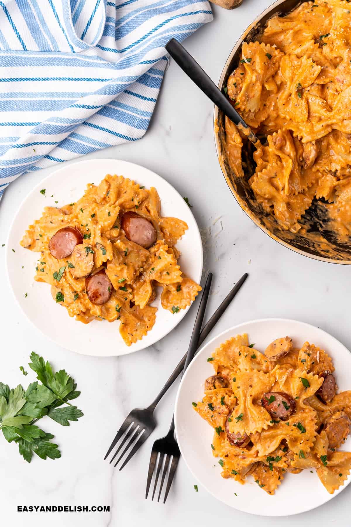 dish serve in a pan and 2 plates on a table