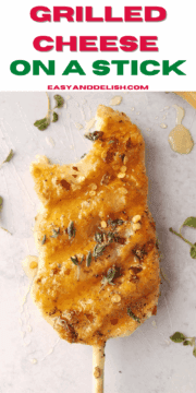 a grilled cheese on a stick drizzled with honey.