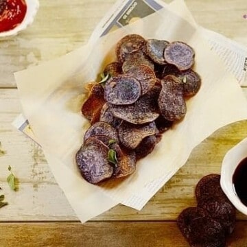 purple potato chips in a paper-lined basket