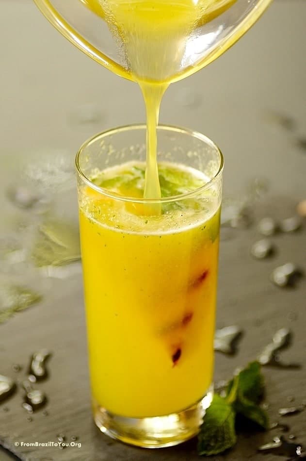 A close up of a glass of pineapple juice