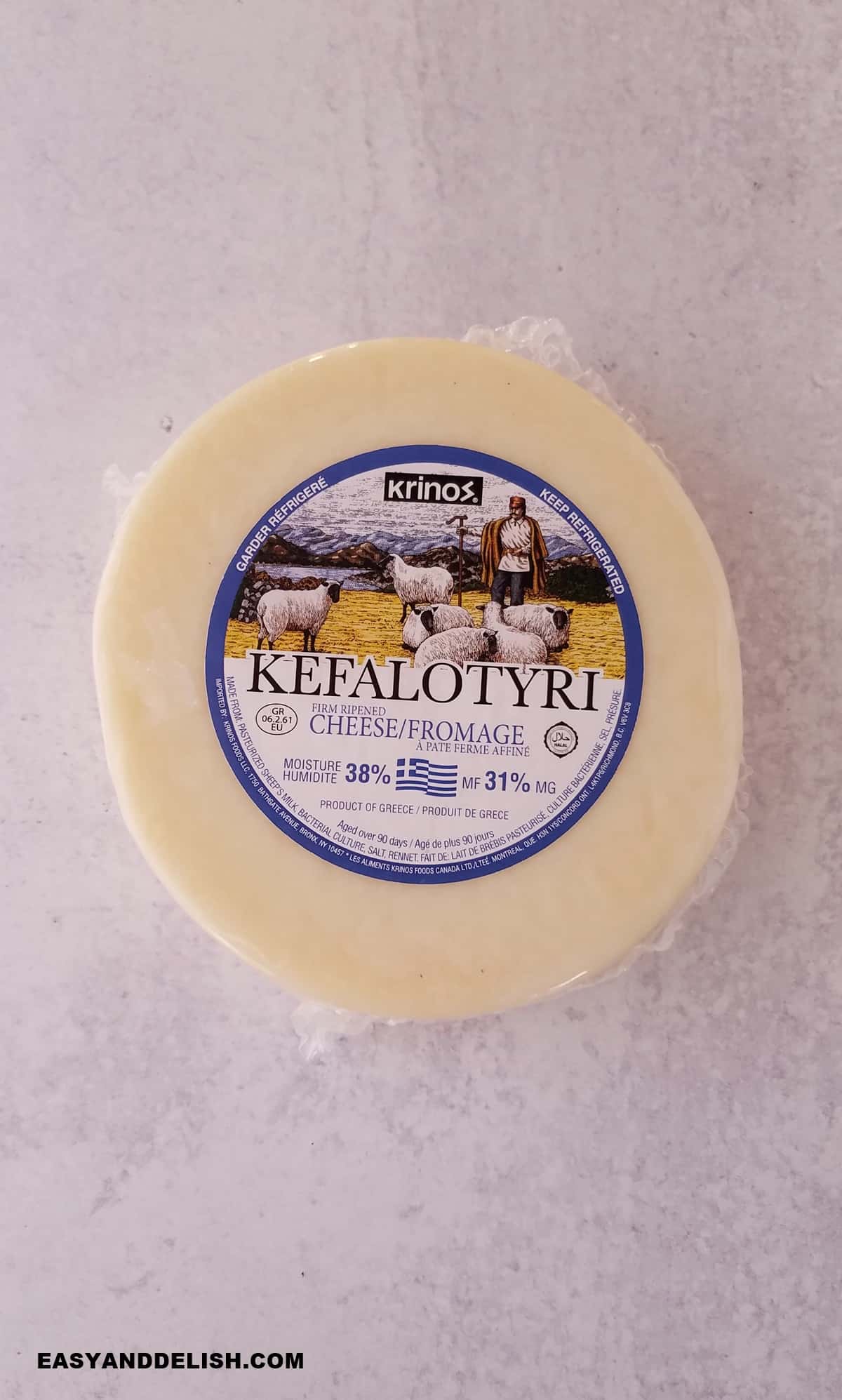 a wheel of kefalotyri on a table.