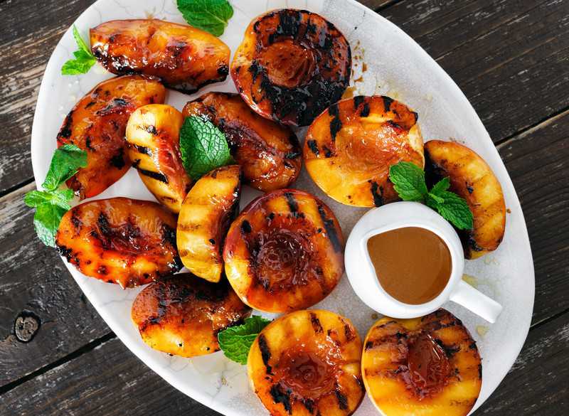 grilled peaches with honey in a platter