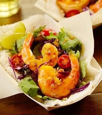 Tapioca crepes filled with seasoned shrimp in a paper basket.