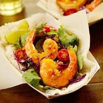 Tapioca crepes filled with seasoned shrimp in a paper basket.