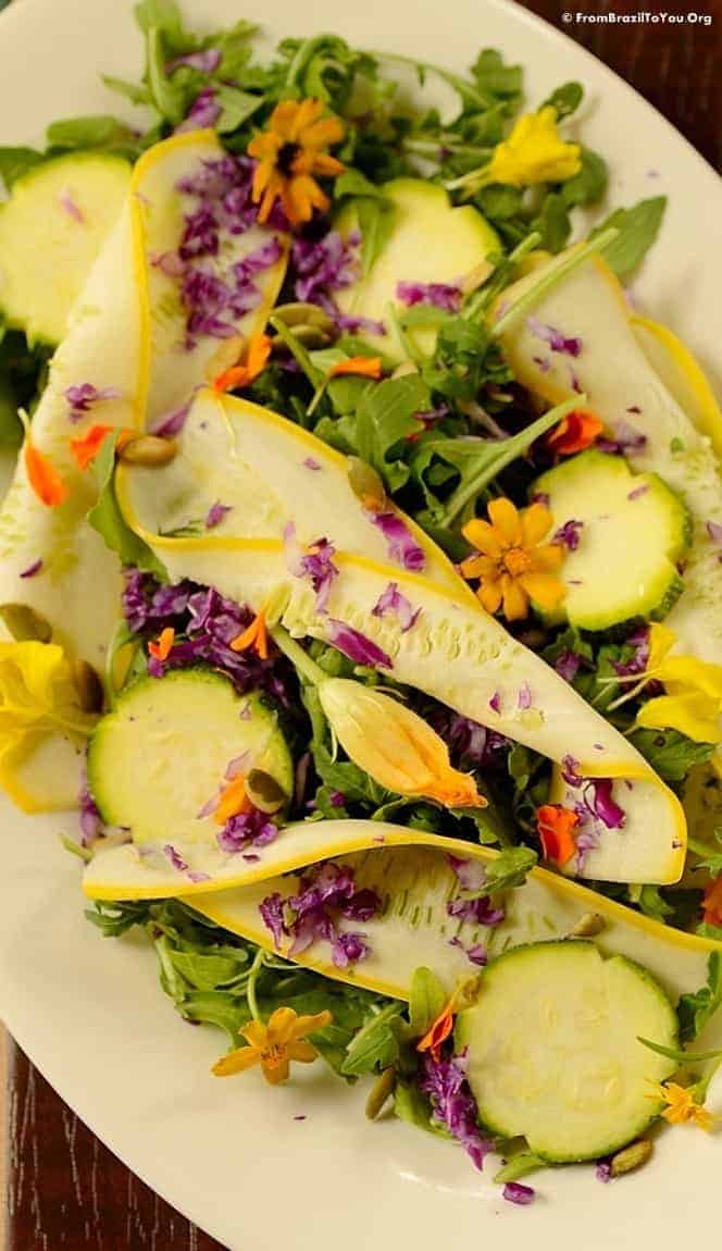 closeup of fall salad garnished with edible flowers