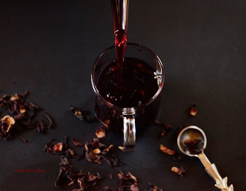 hibiscus tea being poured into a glass