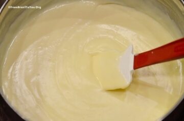 spatula stirring a bowl of yellow custard cream