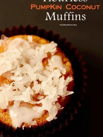 Two pumpkin coconut muffins next to an orange cloth