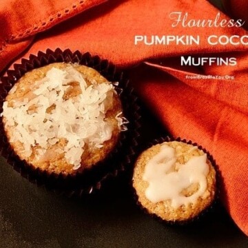 Two pumpkin coconut muffins next to an orange cloth