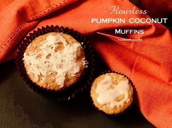 Two pumpkin coconut muffins next to an orange cloth