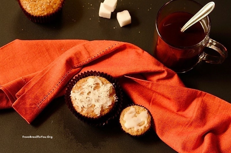 pumpkin coconut muffins with a cup of coffee and sugar cubes on the side