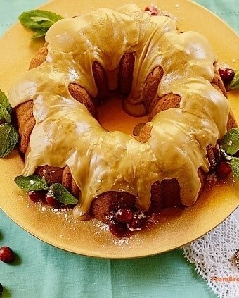 Spiced sweet potato pound cake with caramel frosting on a yellow plate