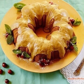 Spiced sweet potato pound cake with caramel frosting on a yellow plate