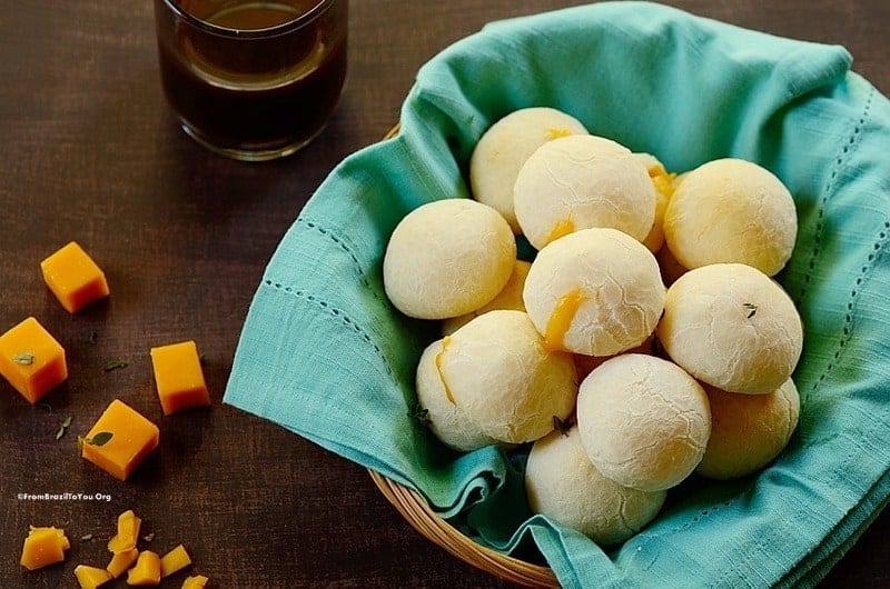 Cheese Rolls in a basket with a cup of coffee and cubes of cheddar on the side