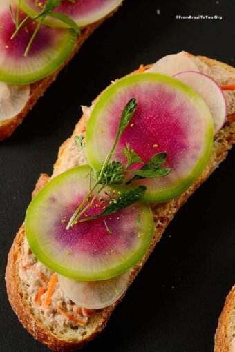 tuna salad sandwich with slice of watermelon radish on top