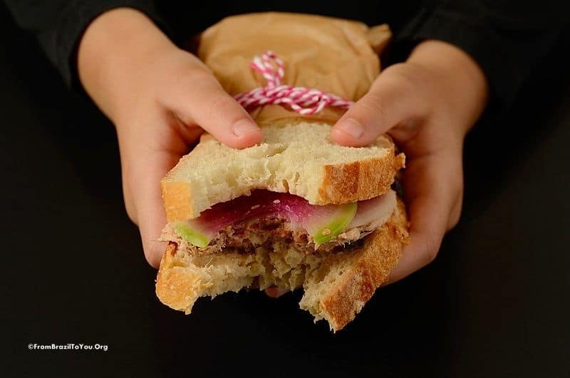 a tuna salad sandwich heald with both hands