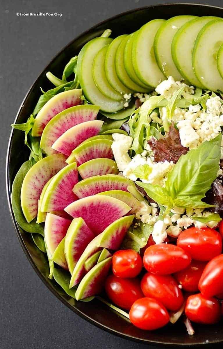 A  plate of salad with vinaigrette dressing 