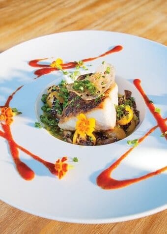 A plate of yellowtail amberjack on a wooden table