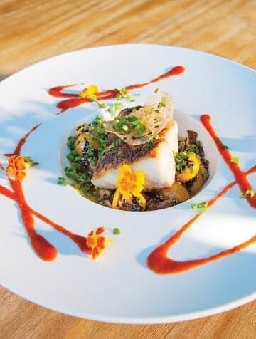 A plate of yellowtail amberjack on a wooden table