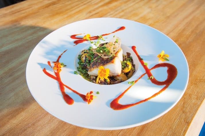 A plate of yellowtail amberjack on a wooden table