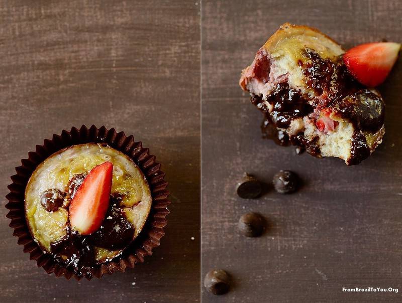 Two chocolate chip banana strawberry muffins on a table