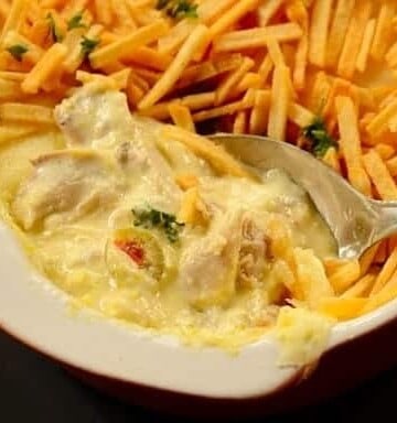 Creamy brazilian chicken fricassee served with shoestring potatoes