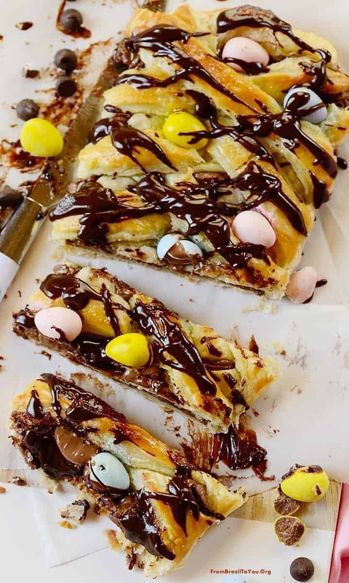 Chocolate pastry braid cut into slices in a baking sheet.