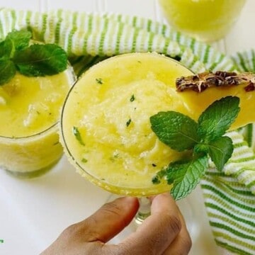 Pineapple margarita topped with mint leaves