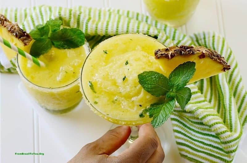 Pineapple margarita topped with mint leaves