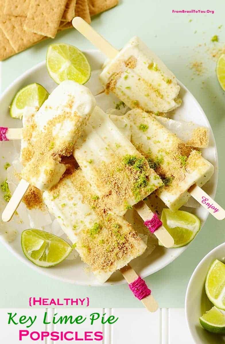 A closeup of a plate with multiple key lime pie popsicles