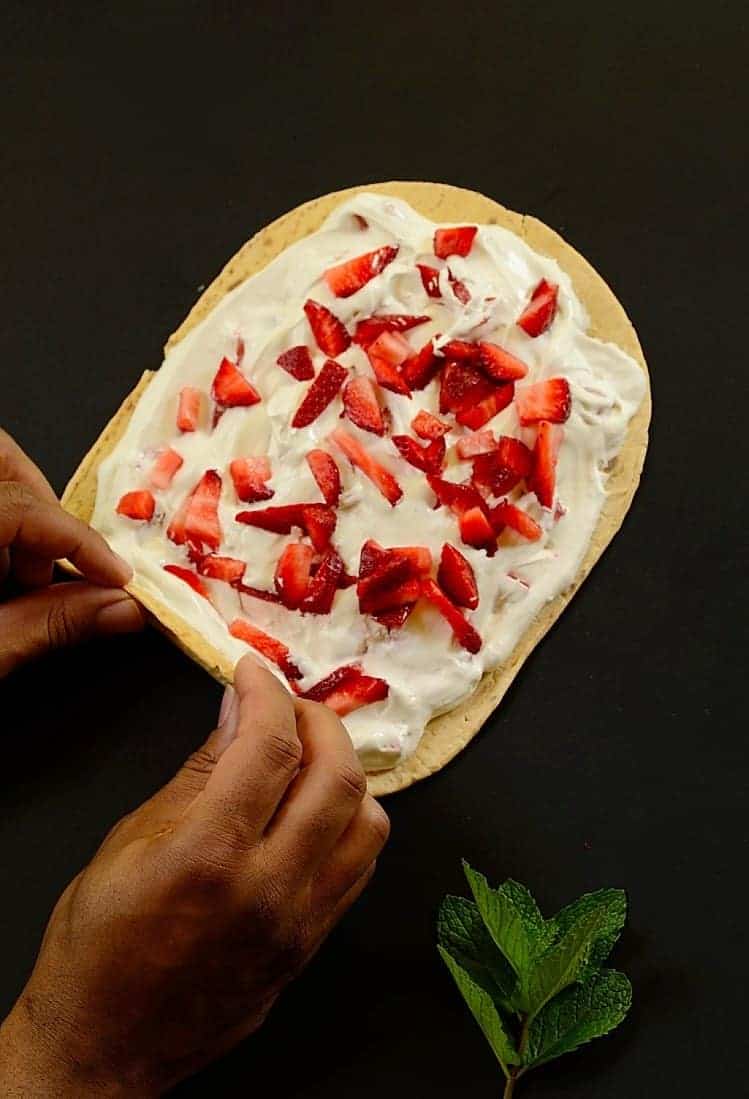 flatbread spread with whipped cream and strawberries