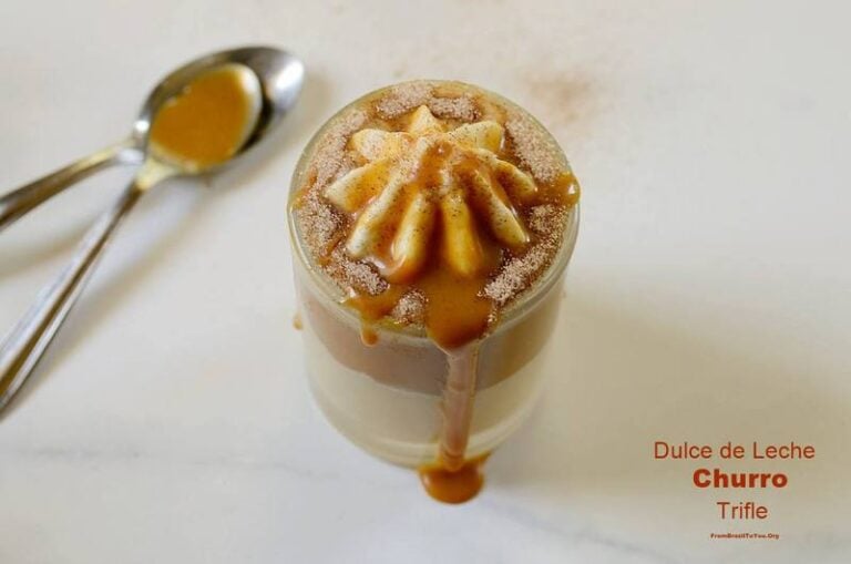 dulce de leche dessert in a glass cup with a spoon beside it