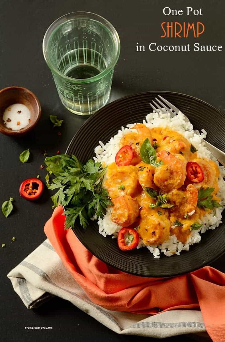 One pot shrimp in coconut sauce on a black plate, also called Camarão no leite de coco