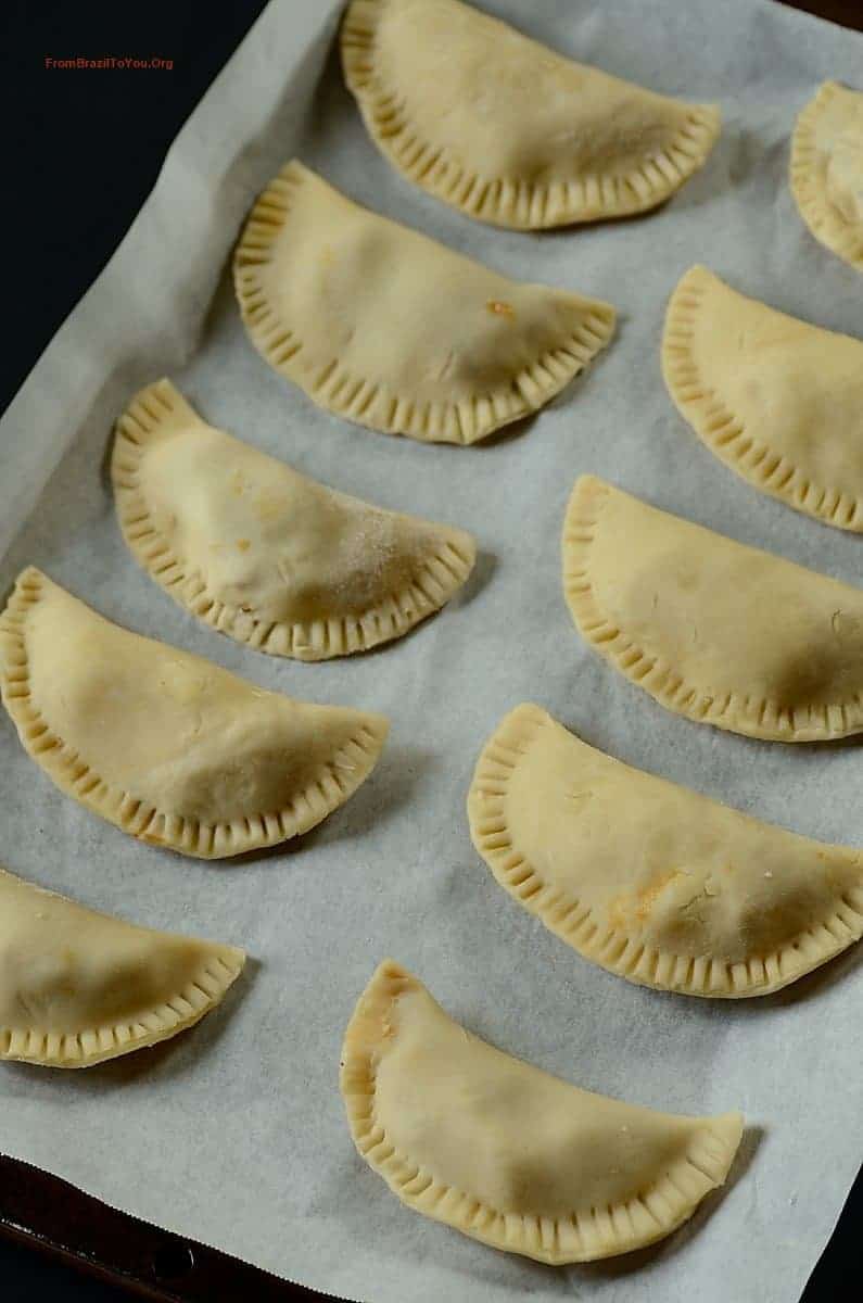 Baking Dulce de Leche Apple Hand Pies onto a lined baking pan before baking