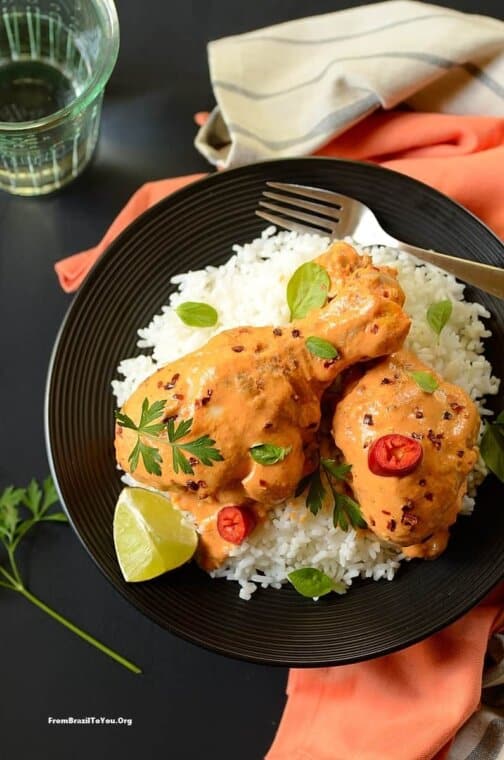 One Pot Chicken in Lime Coconut Sauce served over rice in a plate