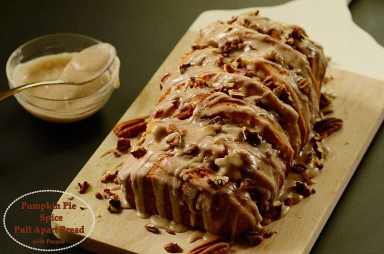 A slice of pumpkin bread on top of a wooden cutting board