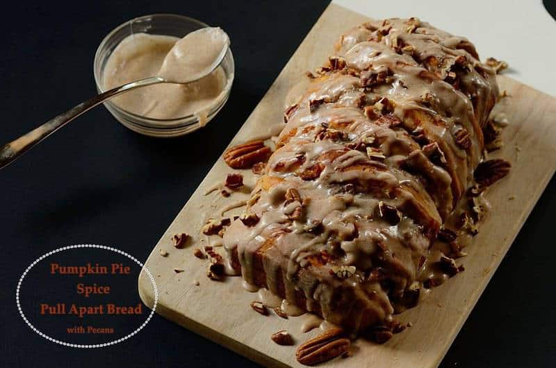 pumpkin spice bread with chopped pecans and glaze on the side