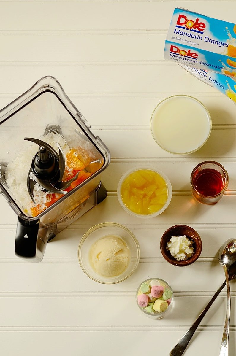 A bunch of foods on a table and a blender