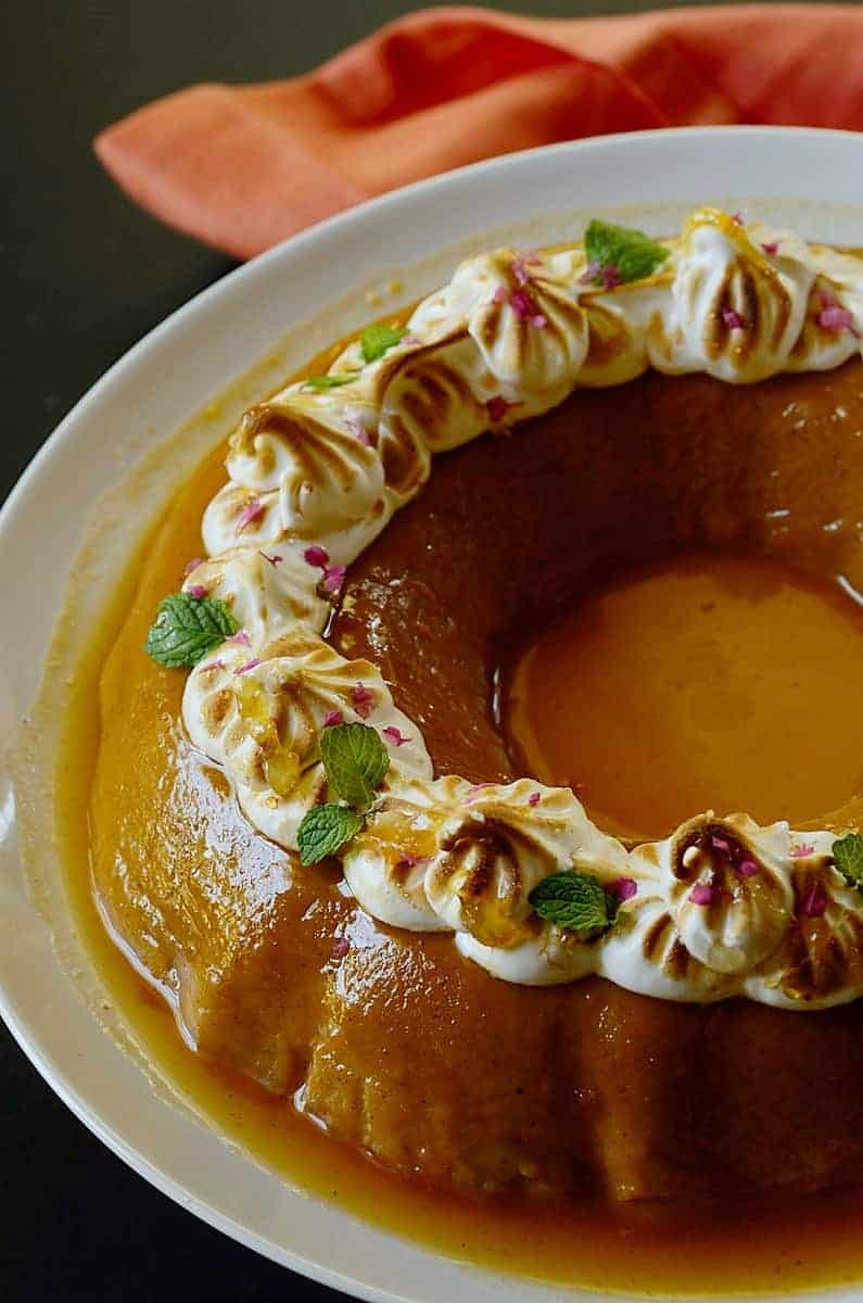 closeup of flan dessert on a plate with caramel glaze