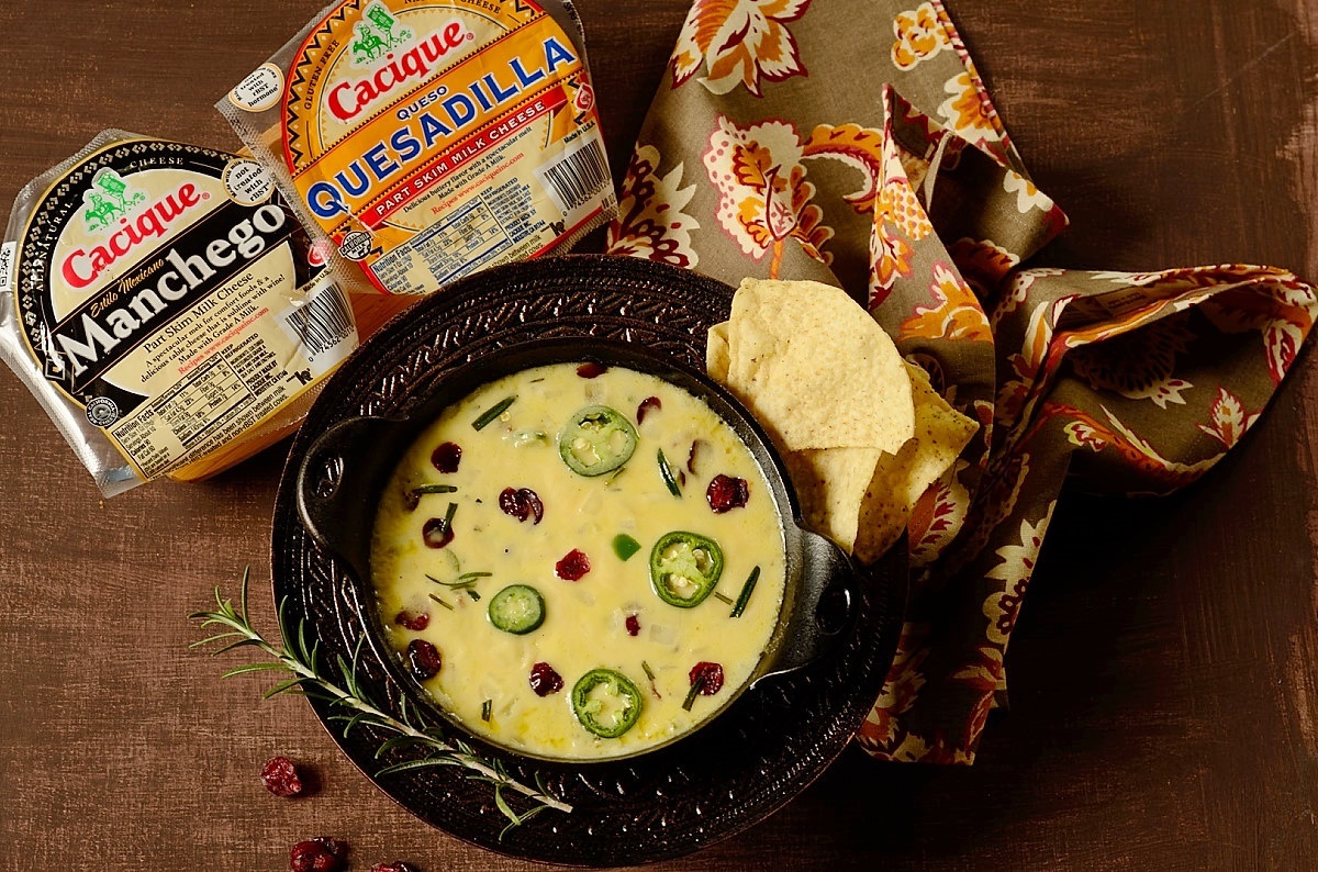 Melted cheese appetizer in a bowl with tortillas on the side.  